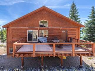 Discover the charm of this stunning cabin, boasting a spacious deck perfect for outdoor relaxation and entertaining.