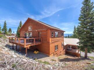 This stunning mountain cabin offers a perfect blend of rustic charm and modern comfort.