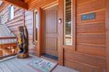 Welcome to your mountain retreat! This charming cabin boasts a warm and inviting entrance, perfect for greeting guests.