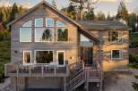 This stunning property boasts a modern design with expansive windows that flood the interior with natural light.
