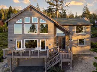 This stunning property boasts a modern design with expansive windows that flood the interior with natural light.