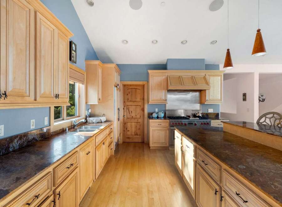 This stunning kitchen boasts a spacious layout, perfect for both cooking and entertaining.