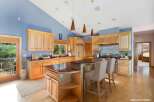 This stunning kitchen boasts a spacious layout with beautiful wooden cabinetry and a large island, perfect for both cooking and entertaining.