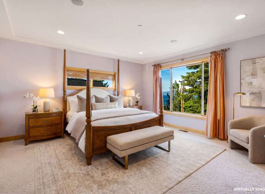 Experience luxury in this stunning bedroom featuring a four-poster bed and elegant furnishings.