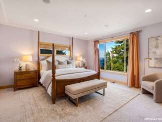 Experience luxury in this stunning bedroom featuring a four-poster bed and elegant furnishings.