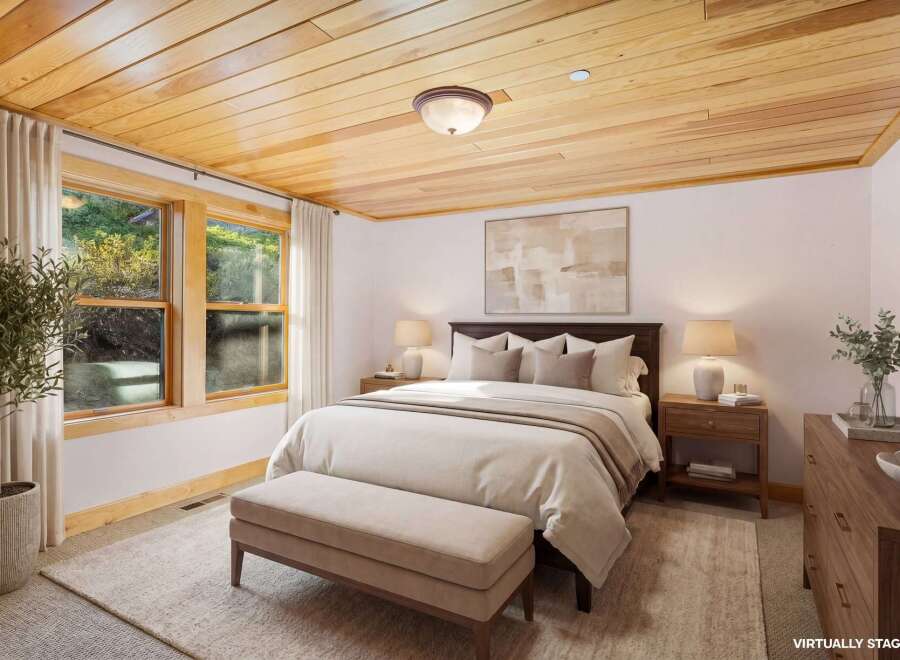 Step into a serene bedroom retreat, featuring a stunning wood plank ceiling that adds warmth and character.