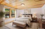 Step into a serene bedroom retreat, featuring a stunning wood plank ceiling that adds warmth and character.
