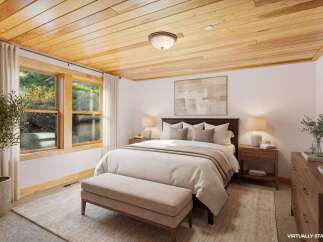 Step into a serene bedroom retreat, featuring a stunning wood plank ceiling that adds warmth and character.
