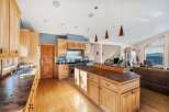 This stunning kitchen boasts custom cabinetry, a large island, and high-end appliances, perfect for culinary enthusiasts.