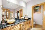 This luxurious bathroom features a stunning black marble countertop with dual sinks, offering ample space and elegance.