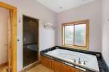 Indulge in luxury within this stunning bathroom, featuring a spacious jacuzzi tub perfect for relaxation.