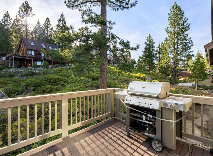 Enjoy outdoor living at its finest with this stunning property featuring a spacious deck and a high-quality Weber grill.