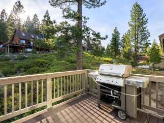 Enjoy outdoor living at its finest with this stunning property featuring a spacious deck and a high-quality Weber grill.