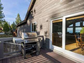 Enjoy outdoor living at its finest with this stunning property featuring a spacious deck and a high-end Weber grill, perfect for entertaining.