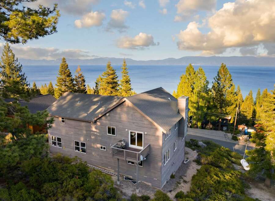 This stunning property offers breathtaking views of the lake and surrounding mountains.