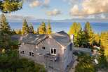 This stunning property offers breathtaking views of the lake and surrounding mountains.