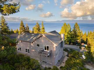 This stunning property offers breathtaking views of the lake and surrounding mountains.