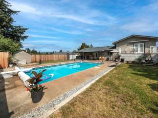 Enjoy the ultimate outdoor oasis with this stunning property! Featuring a sparkling swimming pool, perfect for those hot summer days, and a spacious backyard ideal for entertaining.
