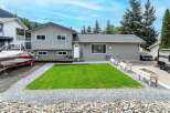 This charming property boasts a well-maintained exterior with a lush green lawn, perfect for outdoor enjoyment.