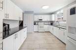 This stunning kitchen boasts a bright and airy atmosphere, perfect for culinary creations and entertaining.