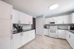 This stunning kitchen boasts bright white cabinetry, offering a clean and modern aesthetic.
