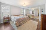 Step into this inviting bedroom, featuring a cozy bed and a plush rug.