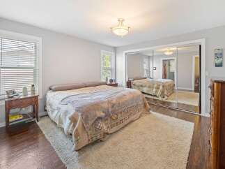 Step into this inviting bedroom, featuring a cozy bed and a plush rug.