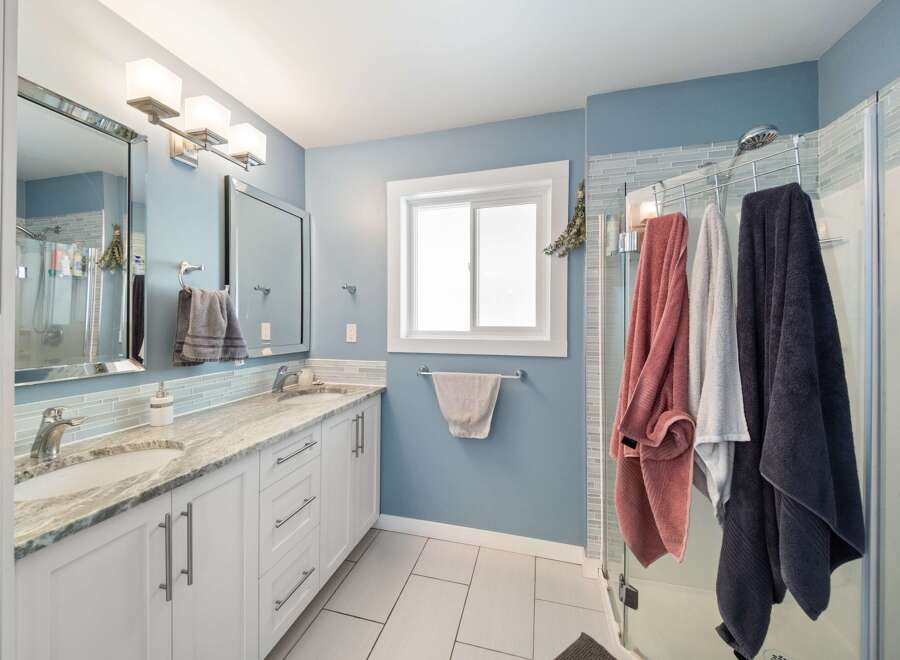 This stunning bathroom boasts a modern design with a touch of elegance.