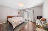 This inviting bedroom features a cozy bed with a stylish patterned comforter, perfect for a relaxing retreat.