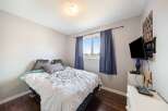 This cozy bedroom offers a comfortable retreat with its inviting ambiance.