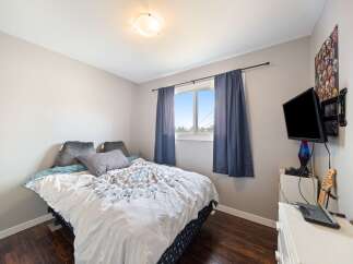 This cozy bedroom offers a comfortable retreat with its inviting ambiance.