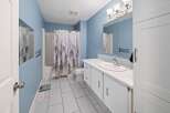 This inviting bathroom features a serene blue color scheme and modern design.