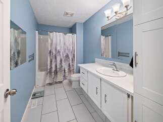 This inviting bathroom features a serene blue color scheme and modern design.