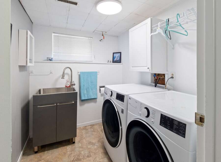 This laundry room offers a functional and organized space for all your washing needs.