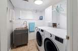 This laundry room offers a functional and organized space for all your washing needs.