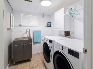 This laundry room offers a functional and organized space for all your washing needs.