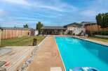 Enjoy the ultimate outdoor living experience with this stunning property featuring a sparkling pool, perfect for those hot summer days.