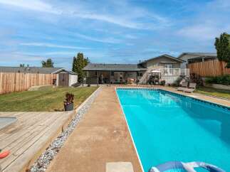 Enjoy the ultimate outdoor living experience with this stunning property featuring a sparkling pool, perfect for those hot summer days.