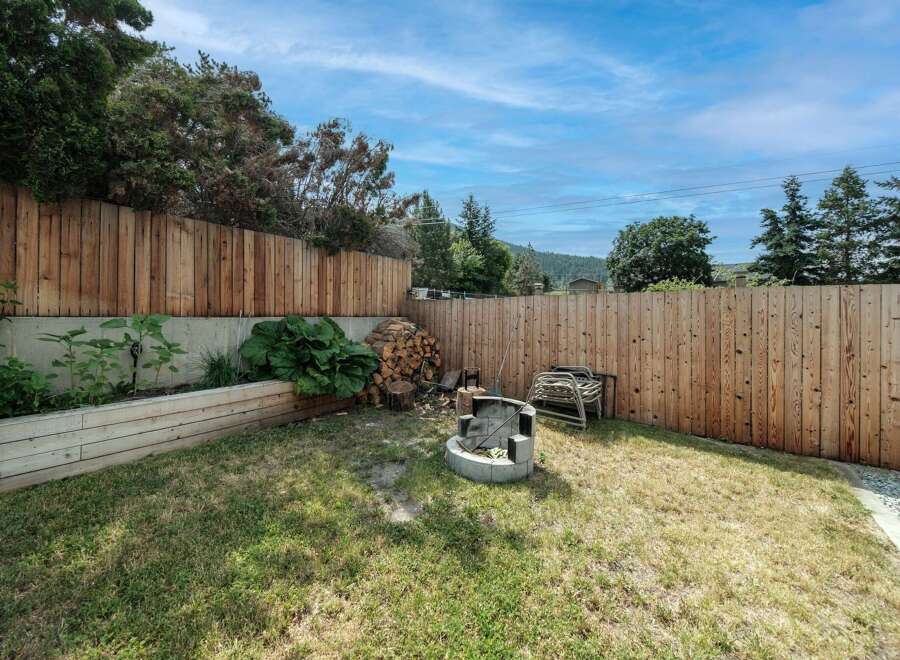 Enjoy the tranquility of this backyard oasis! This property features a spacious, well-maintained lawn, perfect for outdoor activities.