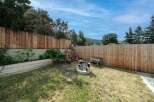 Enjoy the tranquility of this backyard oasis! This property features a spacious, well-maintained lawn, perfect for outdoor activities.
