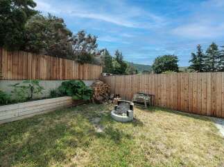 Enjoy the tranquility of this backyard oasis! This property features a spacious, well-maintained lawn, perfect for outdoor activities.