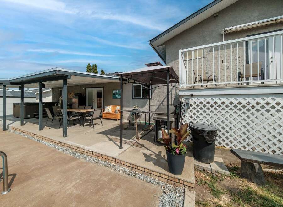 Enjoy outdoor living at its finest with this stunning property featuring a spacious patio and a relaxing hot tub.