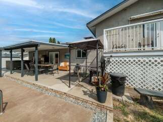 Enjoy outdoor living at its finest with this stunning property featuring a spacious patio and a relaxing hot tub.