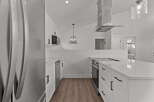 This stunning kitchen boasts modern design with sleek white cabinetry and stainless steel appliances.