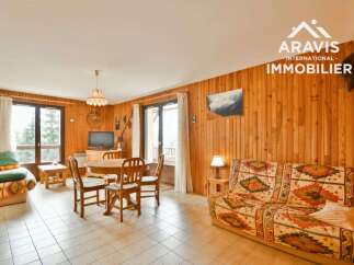 Discover this charming property featuring a cozy living space with wooden paneling and a comfortable sofa.