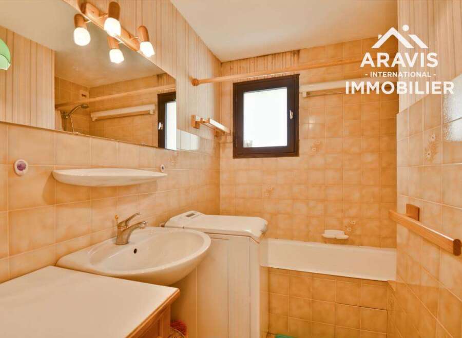 Discover this charming bathroom featuring a sink, a bathtub, and a window, perfect for your daily routines.