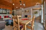 Discover this charming property featuring a cozy dining area with a wooden table and chairs, perfect for family gatherings.