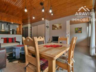 Discover this charming property featuring a cozy dining area with a wooden table and chairs, perfect for family gatherings.