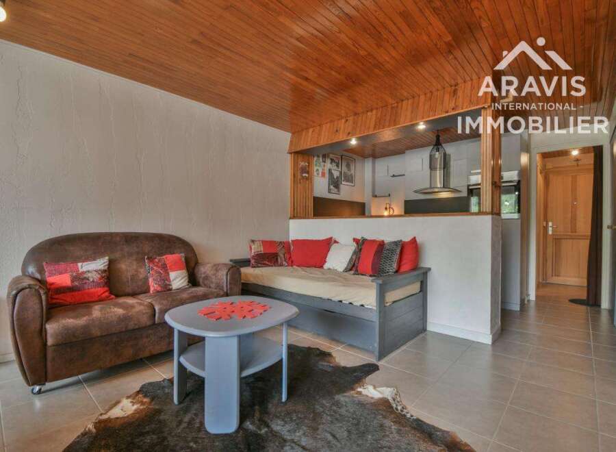 Discover this charming property featuring a cozy living area with a comfortable sofa and a stylish daybed, perfect for relaxation.