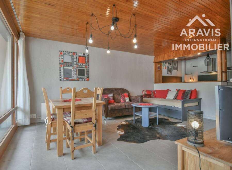 Discover this charming property featuring a cozy living space with a unique wooden ceiling and stylish decor.